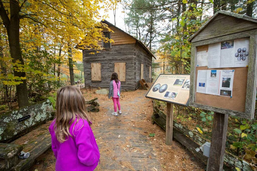 kids exploring log house at Hartman Creek Wisconsin State Park in Waupaca