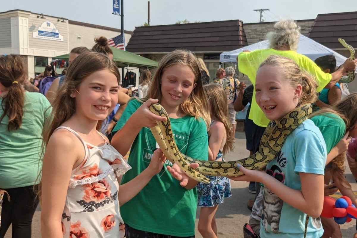 girls with snake at market on main