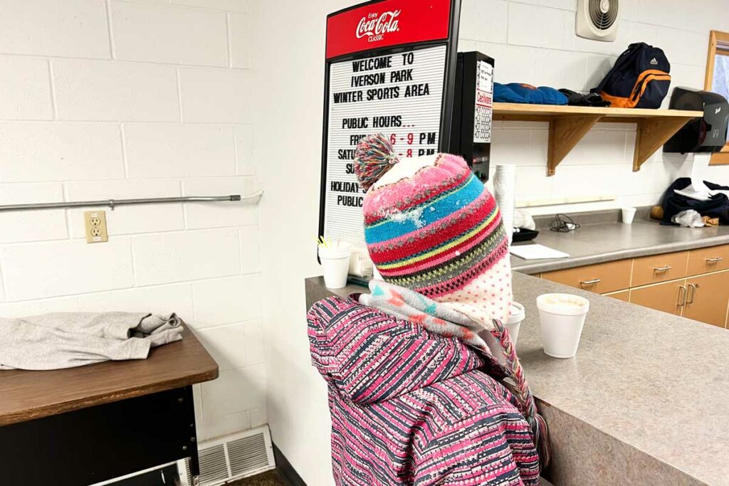 Kid buying hot chocolate at Iverson Park Winter Sports Area