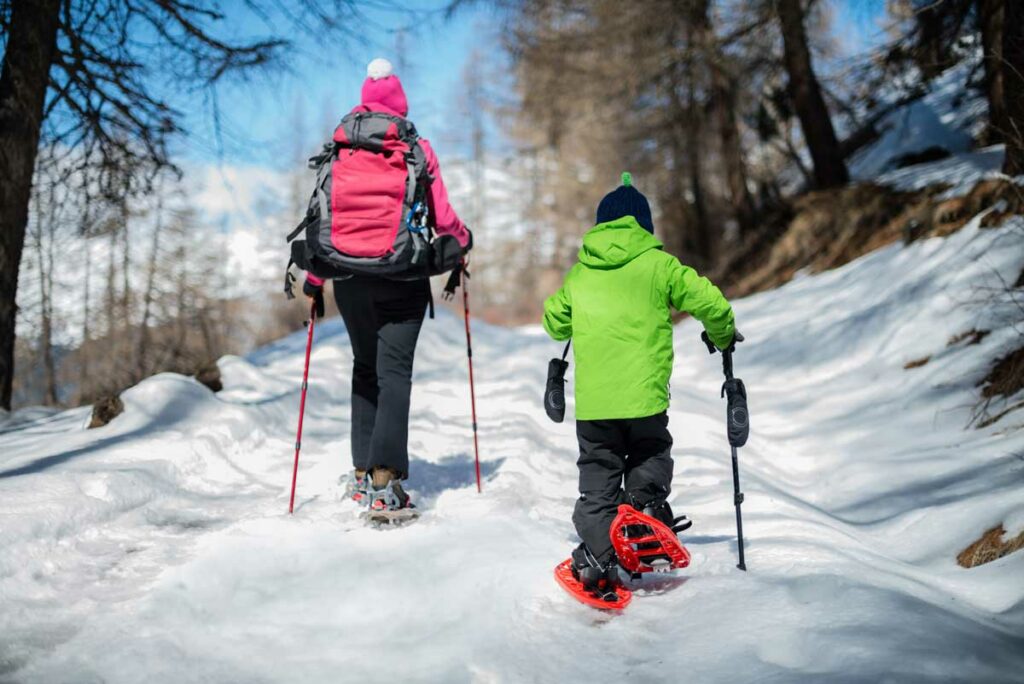 Mother and child on snowshoe trail.